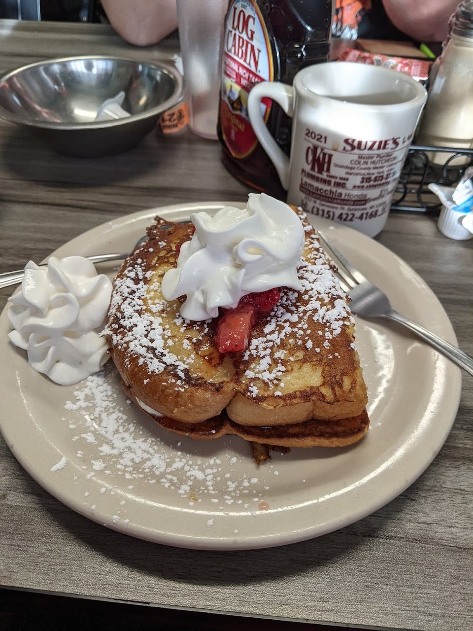 Breakfast menu with sandwiches, pancakes, and waffles.